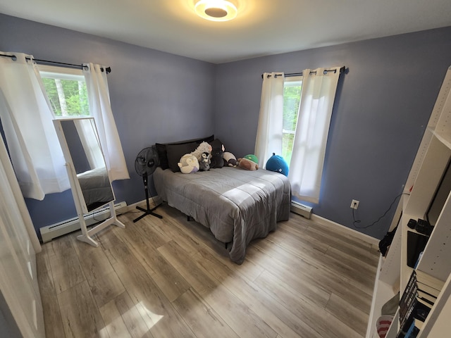 1083 N Rd, Newburgh, ME 04444 - bedroom with baseboard heating and wood finished floors