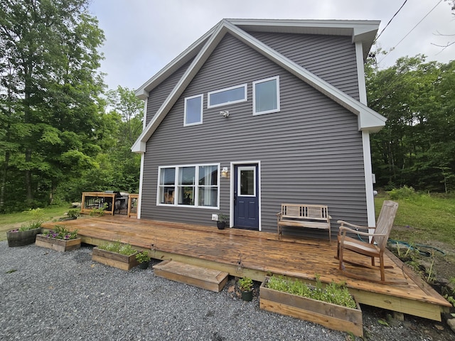 1083 N Rd, Newburgh, ME 04444 - back of property with a garden and a wooden deck