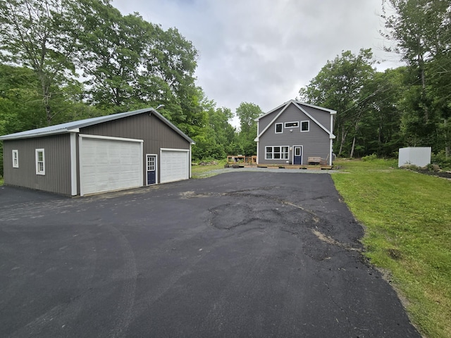 1083 N Rd, Newburgh, ME 04444 - view of front of home with a detached garage, an outdoor structure, and a front lawn