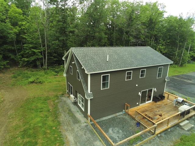 1083 N Rd, Newburgh, ME 04444 - rear view of house featuring a shingled roof, a wooden deck, and a forest view