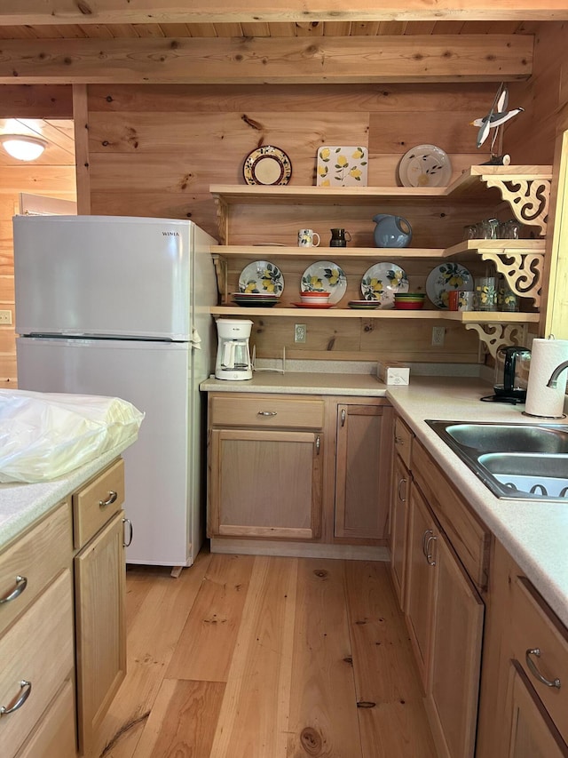 704 Sawyers Mills Rd, Starks, ME 04911 - kitchen with freestanding refrigerator, open shelves, light wood-style floors, wood walls, and light countertops