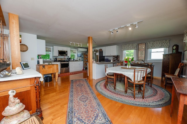 365 Waterville Rd, Skowhegan, ME 04976 - dining room with track lighting, light wood-style floors, and a wall unit AC