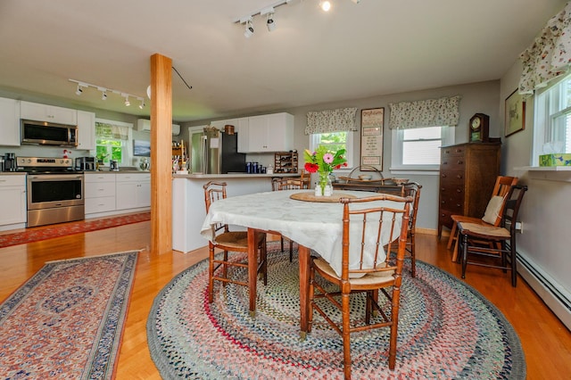 365 Waterville Rd, Skowhegan, ME 04976 - dining room featuring rail lighting, a baseboard radiator, and light wood finished floors
