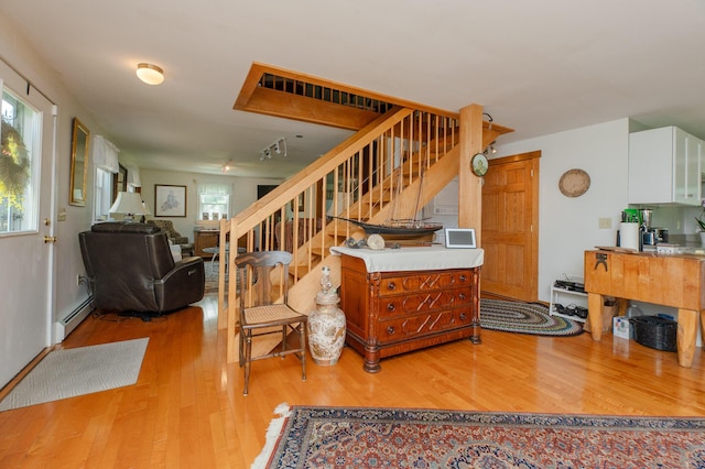 365 Waterville Rd, Skowhegan, ME 04976 - stairway featuring wood finished floors and a baseboard radiator