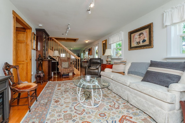 365 Waterville Rd, Skowhegan, ME 04976 - living area featuring rail lighting, stairs, and wood finished floors