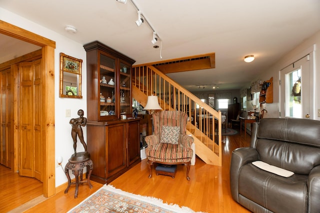 365 Waterville Rd, Skowhegan, ME 04976 - living room featuring light wood-style flooring, stairway, and track lighting