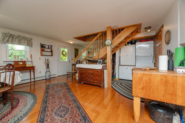 365 Waterville Rd, Skowhegan, ME 04976 - interior space featuring stacked washer / dryer, wood finished floors, butcher block counters, and a baseboard radiator