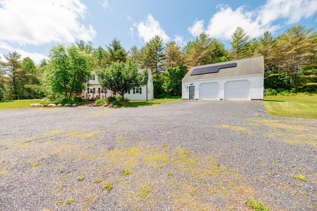 365 Waterville Rd, Skowhegan, ME 04976 - detached garage featuring solar panels and view of scattered trees