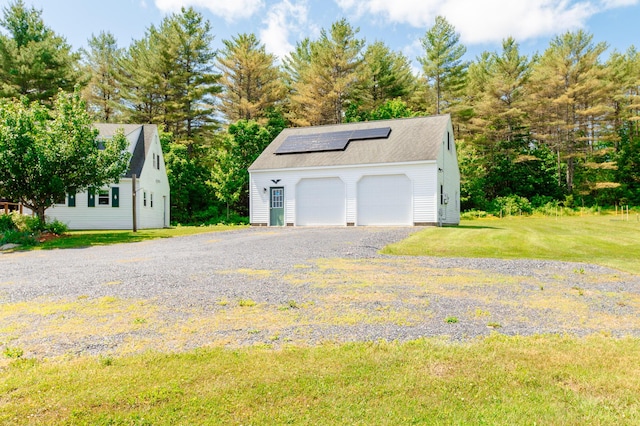 365 Waterville Rd, Skowhegan, ME 04976 - detached garage featuring solar panels and view of wooded area