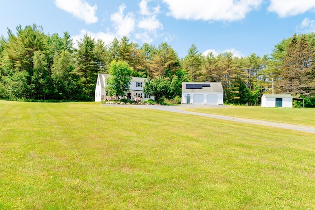 365 Waterville Rd, Skowhegan, ME 04976 - view of green lawn featuring an outbuilding, a detached garage, and view of scattered trees