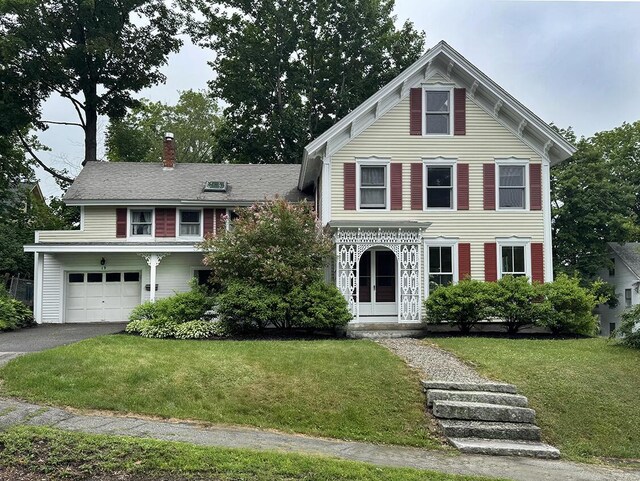 19 Union St, Hallowell, ME 04347 - view of front of house featuring a front lawn, a garage, a chimney, and driveway