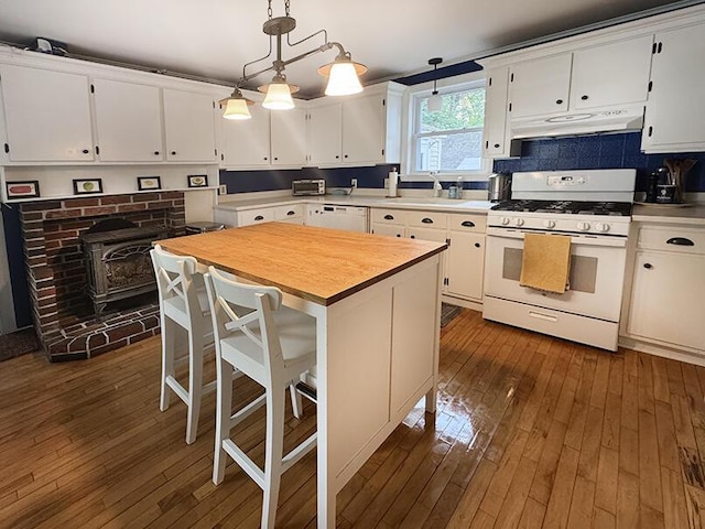 19 Union St, Hallowell, ME 04347 - kitchen featuring white appliances, under cabinet range hood, dark wood finished floors, and white cabinetry