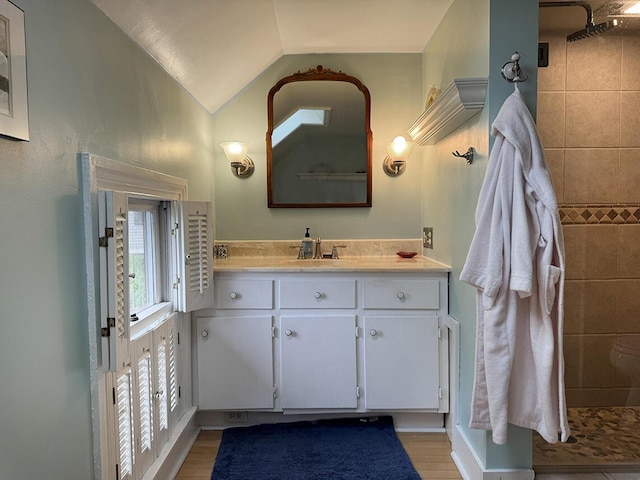 19 Union St, Hallowell, ME 04347 - bathroom with vanity, vaulted ceiling, wood finished floors, and tiled shower