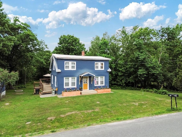 171 Bassett Rd, Winslow, ME 04901 - view of front of house featuring a deck, a chimney, and a front yard
