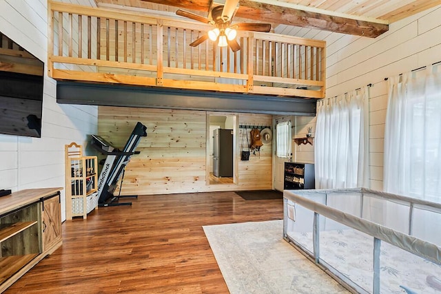 171 Bassett Rd, Winslow, ME 04901 - unfurnished bedroom featuring wood walls, beamed ceiling, wood finished floors, a towering ceiling, and freestanding refrigerator