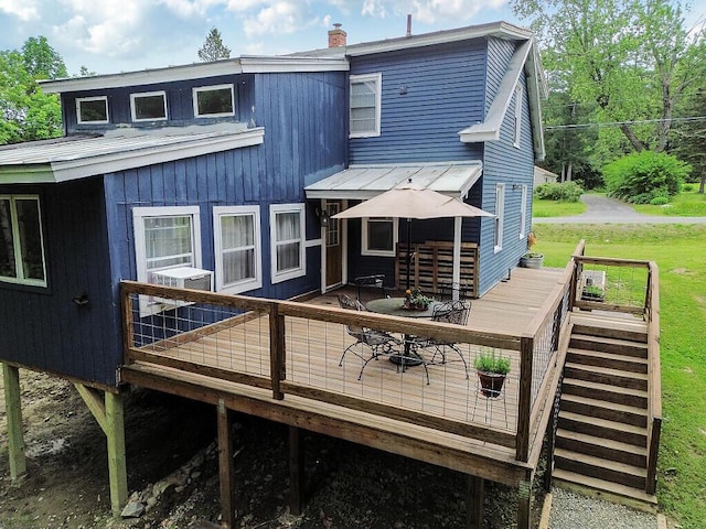 171 Bassett Rd, Winslow, ME 04901 - back of property featuring a deck, a chimney, a lawn, and cooling unit