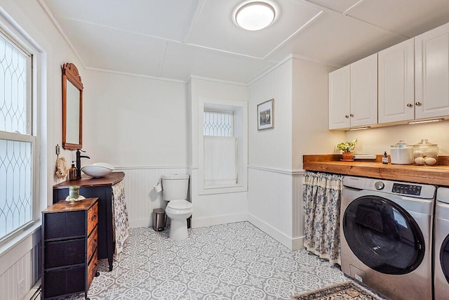 171 Bassett Rd, Winslow, ME 04901 - laundry area with washer and clothes dryer, a wainscoted wall, ornamental molding, and light tile patterned floors