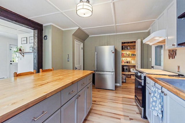 171 Bassett Rd, Winslow, ME 04901 - kitchen with freestanding refrigerator, butcher block counters, range with electric stovetop, under cabinet range hood, and gray cabinets