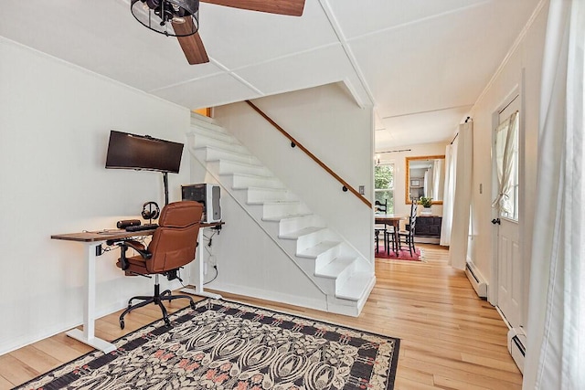 171 Bassett Rd, Winslow, ME 04901 - home office with light wood-type flooring, ceiling fan, and a baseboard heating unit