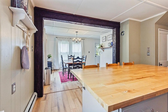 171 Bassett Rd, Winslow, ME 04901 - kitchen featuring light wood finished floors, a chandelier, baseboard heating, and wood counters