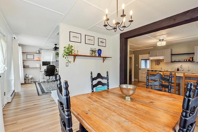 171 Bassett Rd, Winslow, ME 04901 - dining space with light wood finished floors, a ceiling fan, a baseboard radiator, a chandelier, and a desk