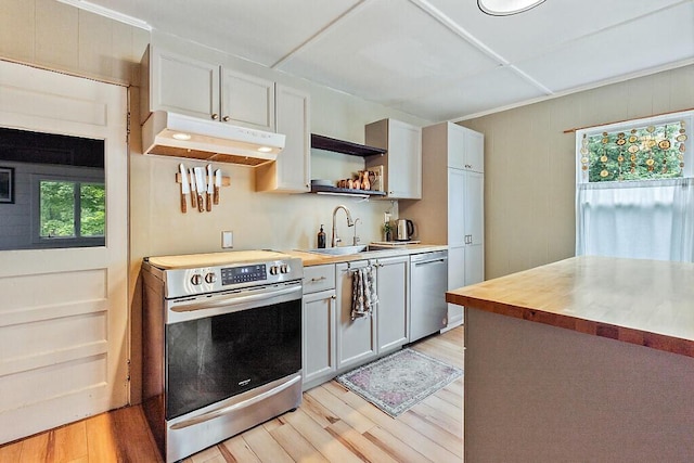 171 Bassett Rd, Winslow, ME 04901 - kitchen with stainless steel appliances, under cabinet range hood, light wood finished floors, and open shelves