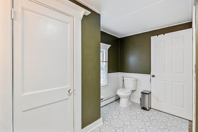 171 Bassett Rd, Winslow, ME 04901 - half bath featuring a baseboard heating unit, wainscoting, and tile patterned floors