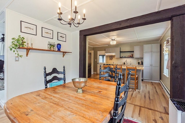 171 Bassett Rd, Winslow, ME 04901 - dining room featuring light wood finished floors, coffered ceiling, a chandelier, baseboard heating, and beam ceiling