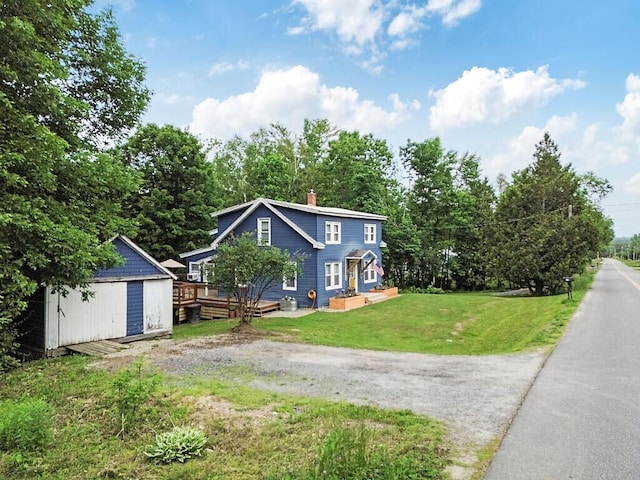 171 Bassett Rd, Winslow, ME 04901 - view of property exterior featuring a storage shed, a wooden deck, a chimney, and a yard