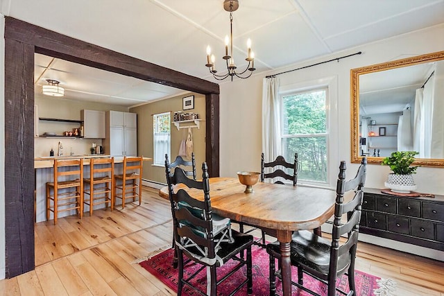 171 Bassett Rd, Winslow, ME 04901 - dining area with light wood-style flooring, a chandelier, and a baseboard heating unit