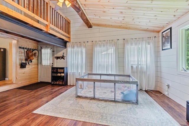 171 Bassett Rd, Winslow, ME 04901 - unfurnished living room with lofted ceiling, wood walls, wood finished floors, a ceiling fan, and wood ceiling