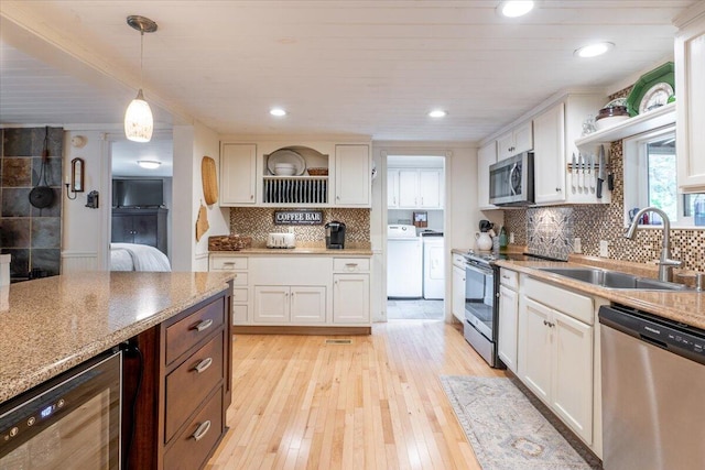 25 Pine View Ridge Rd, Boothbay, ME 04537 - kitchen with stainless steel appliances, washer / clothes dryer, wine cooler, light wood-style floors, and recessed lighting