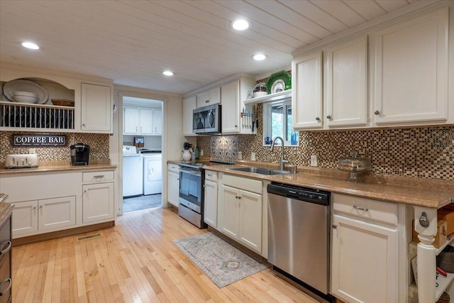 25 Pine View Ridge Rd, Boothbay, ME 04537 - kitchen featuring appliances with stainless steel finishes, washing machine and clothes dryer, backsplash, light wood-style flooring, and recessed lighting