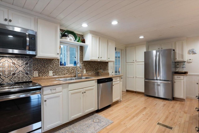 25 Pine View Ridge Rd, Boothbay, ME 04537 - kitchen with appliances with stainless steel finishes, light wood-style flooring, backsplash, recessed lighting, and white cabinets