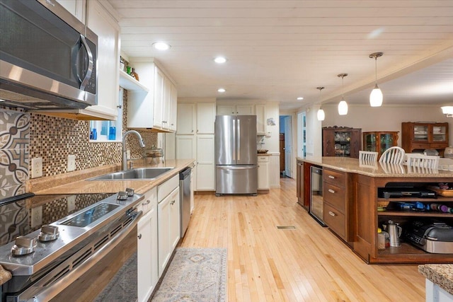 25 Pine View Ridge Rd, Boothbay, ME 04537 - kitchen featuring appliances with stainless steel finishes, wine cooler, white cabinets, light wood-style floors, and recessed lighting