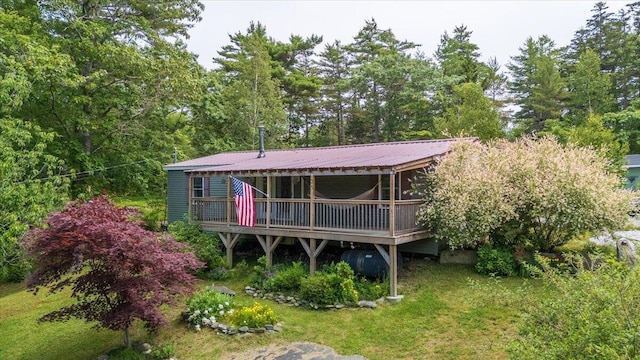 25 Pine View Ridge Rd, Boothbay, ME 04537 - back of house with a deck, oil tank, a metal roof, and a yard