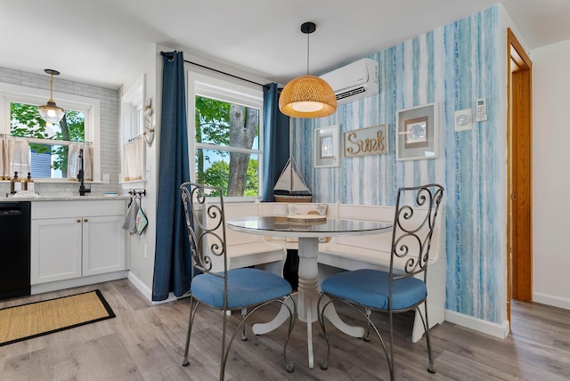 11 Farmhouse Way Unit 11, Ogunquit, ME 03907 - dining space with healthy amount of natural light, light wood-type flooring, a wall unit AC, and wallpapered walls