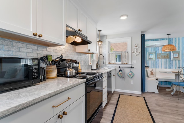 11 Farmhouse Way Unit 11, Ogunquit, ME 03907 - kitchen featuring black appliances, under cabinet range hood, white cabinets, decorative backsplash, and a wall mounted air conditioner