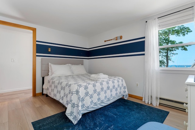 11 Farmhouse Way Unit 11, Ogunquit, ME 03907 - bedroom with a baseboard heating unit and wood finished floors