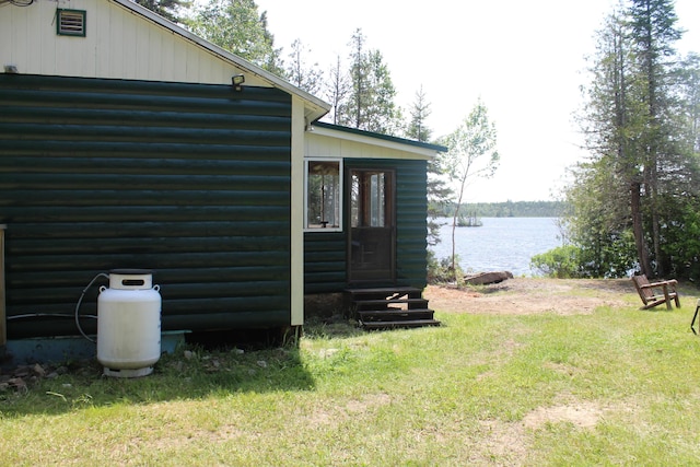 189 E Shore Rd, Benedicta Twp, ME 04733 - view of side of property featuring a water view, a yard, entry steps, and faux log siding