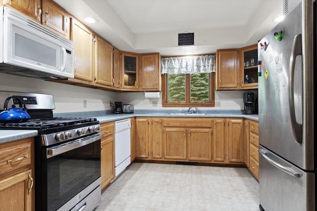 14 Moody Pond Rd, Windsor, ME 04363 - kitchen featuring appliances with stainless steel finishes, light countertops, glass insert cabinets, and brown cabinets