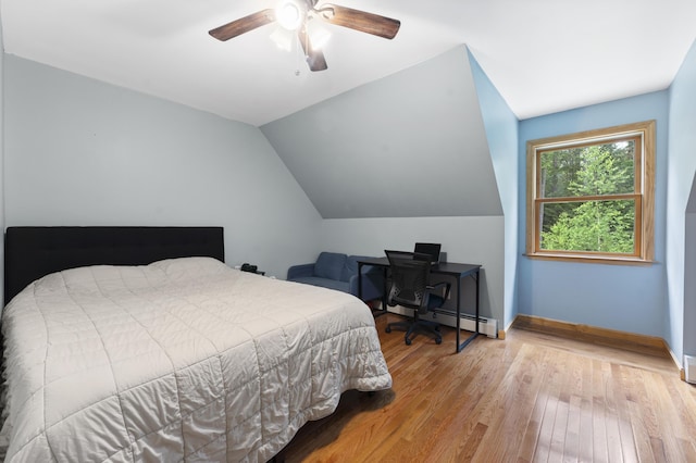 14 Moody Pond Rd, Windsor, ME 04363 - bedroom with baseboard heating, wood finished floors, vaulted ceiling, and ceiling fan