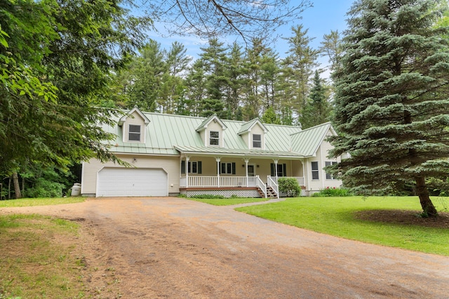 14 Moody Pond Rd, Windsor, ME 04363 - cape cod-style house with a porch, driveway, a front lawn, a metal roof, and a standing seam roof