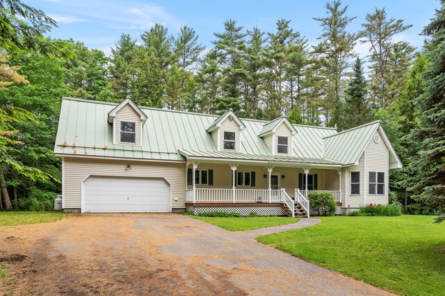 14 Moody Pond Rd, Windsor, ME 04363 - cape cod home with a porch, asphalt driveway, a standing seam roof, an attached garage, and a front yard