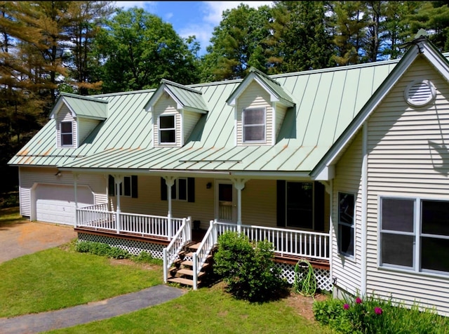 14 Moody Pond Rd, Windsor, ME 04363 - view of front of home with a standing seam roof, a porch, a front lawn, and a metal roof
