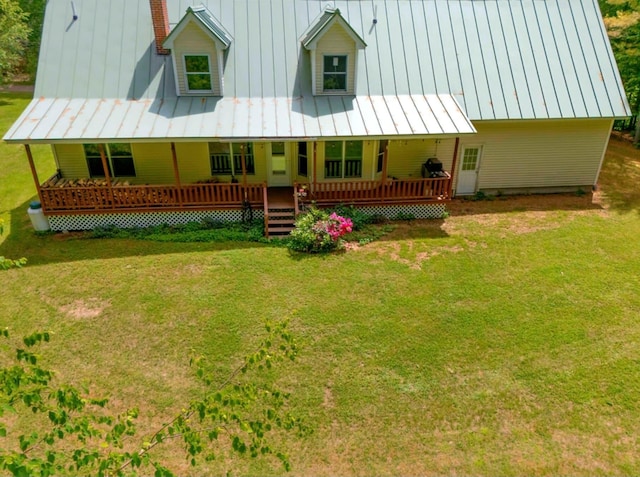 14 Moody Pond Rd, Windsor, ME 04363 - rear view of property with a standing seam roof, a porch, a chimney, and a yard