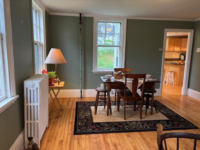 37 Central St, Hallowell, ME 04347 - dining space with radiator, hardwood / wood-style floors, and ornamental molding