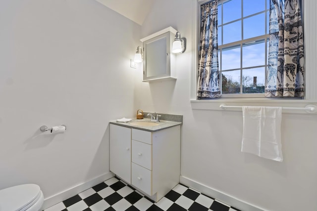 37 Central St, Hallowell, ME 04347 - half bath with tile patterned floors, vanity, and vaulted ceiling