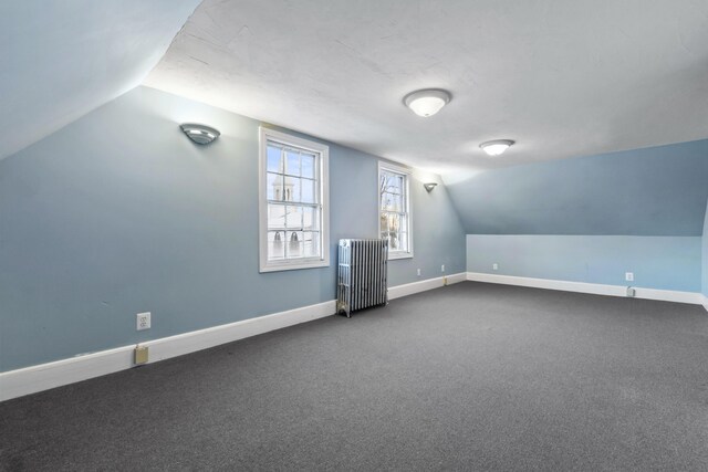37 Central St, Hallowell, ME 04347 - bonus room with radiator heating unit, lofted ceiling, and dark carpet