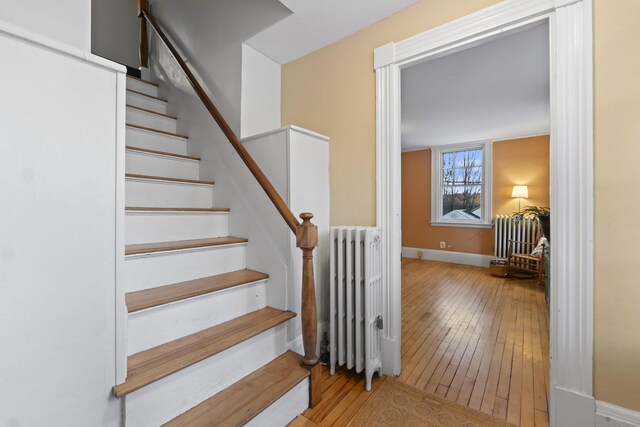 37 Central St, Hallowell, ME 04347 - staircase with radiator heating unit and wood-type flooring